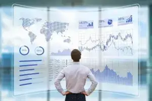 man is standing infront of a graph of percentage