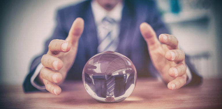 two hands covering a small crystal ball